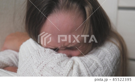 A teenage child cries and tears run down her cheeks. The girl is upset due to hormonal changes in the body. Children's nervousness from problems with peers and parents. Lifestyle soul cry. Fear and 85522395