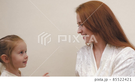 Little child hugs mom and laughs. Happy girl rejoices at mommy. A daughter and a woman are playing in the children's room. Mothers Day. Parents' love for kid. Upbringing on maternity leave. Family Little child hugs mom and laughs. Happy girl rejoices at mommy. A daughter and a woman are playing in the children's room. Mothers Day. Parents' love for kid. Upbringing on maternity leave. Family 85522421