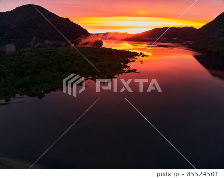 Calm Bled lake at sunrise with clouds in a sky. 85524501