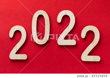 2022 year wooden numbers lying on the red paper background with shadows 2022 year wooden numbers lying on the red paper background with shadows 85525859
