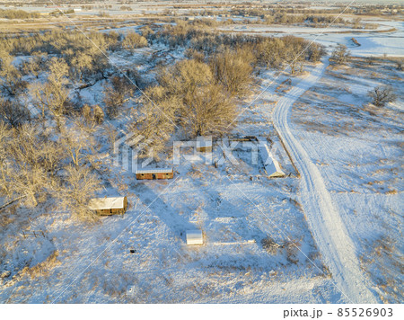 abandoned farm and river at winter sunset 85526903