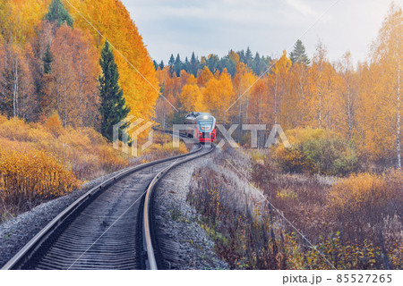 Passenger diesel local train moves to Sortavala at autumn day time. Karelia. Passenger diesel local train moves to Sortavala at autumn day time. Karelia. 85527265