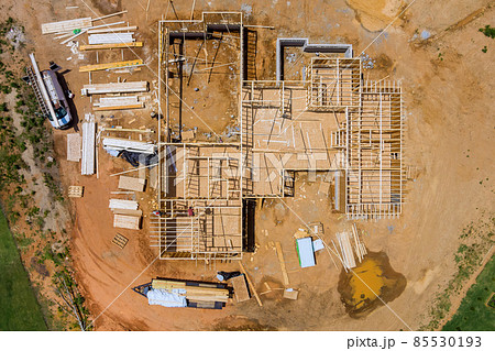 Aerial view of fragment a new home under construction wood framing beams framework Aerial view of fragment a new home under construction wood framing beams framework 85530193