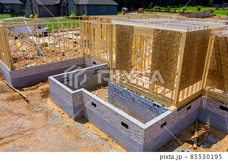 Aerial view the construction wood framing beams of a new house under construction 85530195