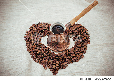 Coffee turk and roasted beans on burlap background. Coffee turk and roasted beans on burlap background. 85532922