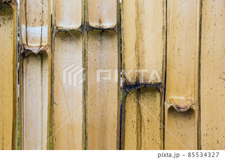 Old brown tone bamboo simple wall or Bamboo fence texture background for interior or exterior design vintage tone. Brown bamboo stick pattern backdrop. Local area urban house protection from thief. 85534327