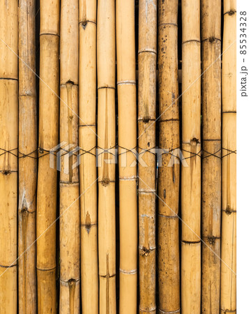 Old brown tone bamboo simple wall or Bamboo fence texture background for interior or exterior design vintage tone. Brown bamboo stick pattern backdrop. Local area urban house protection from thief. 85534328
