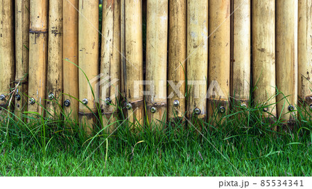 Old brown tone bamboo simple wall or Bamboo fence texture background for exterior design vintage tone. Brown bamboo stick pattern backdrop. Local area urban house protection from thief. Old brown tone bamboo simple wall or Bamboo fence texture background for exterior design vintage tone. Brown bamboo stick pattern backdrop. Local area urban house protection from thief. 85534341
