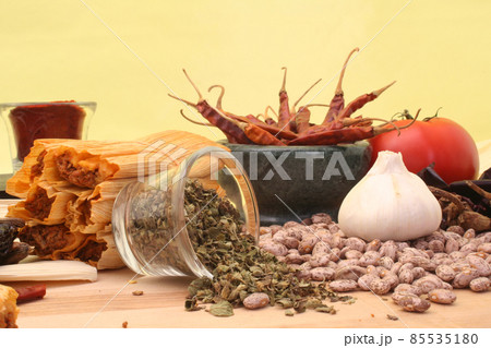 Tamales With Garlic, Beans and Tomato on Yellow Background 85535180