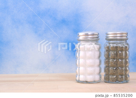 Salt and Pepper Shakers on Blue Background Salt and Pepper Shakers on Blue Background 85535200