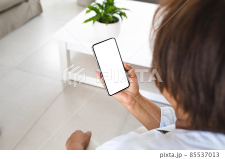 Senior woman using smart phone with copy space in living room at home Senior woman using smart phone with copy space in living room at home 85537013
