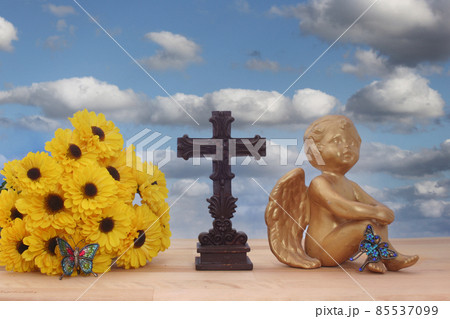 Flowers and Angel with Cross and Butterflies on Blue Sky Background 85537099