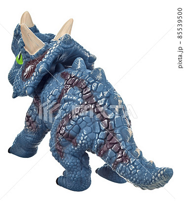 Toy dinosaur of bluish color with green eyes, an open mouth and horns on its head, isolated on a white background. Rear view. Toy dinosaur of bluish color with green eyes, an open mouth and horns on its head, isolated on a white background. Rear view. 85539500