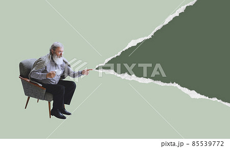 Senior man wearing retro style clothes sitting in armchair isolated on torn paper background. Contemporary art collage. Minimalism 85539772