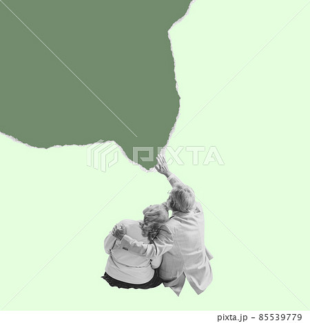 Senior man and woman wearing retro style clothes sit with their backs to camera and looking up isolated on torn paper background. Minimalism Senior man and woman wearing retro style clothes sit with their backs to camera and looking up isolated on torn paper background. Minimalism 85539779