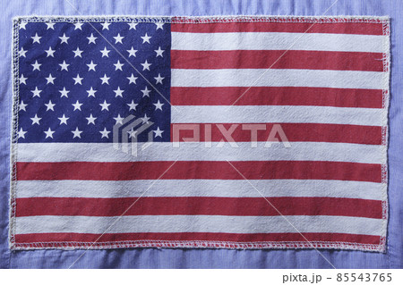 USA flag on fabric texture sewn to blue fabric USA flag on fabric texture sewn to blue fabric 85543765