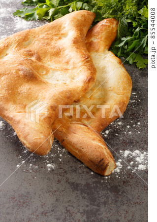 Shotis puri or shoti is a Georgian bread made with whole wheat flour, salt, water, and yeast close up. Vertical 85544008