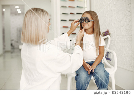 Child in a glasses store check his eyes Child in a glasses store check his eyes 85545196