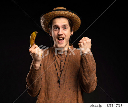 Young man with banana on black 85547384