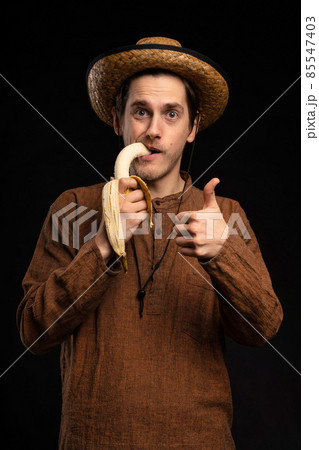 Young man with banana on black 85547403
