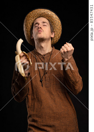 Young man with banana on black 85547431
