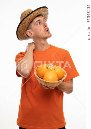 Young man with oranges on white 85548156