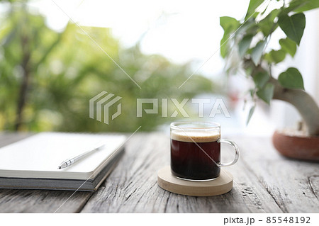 Coffee with crema and glass cup and notebook Coffee with crema and glass cup and notebook 85548192