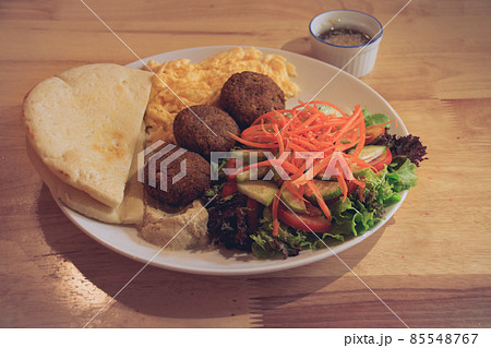 Pita bread, falafel, hummus, salad and scrambled eggs for a healthy modern middle eastern breakfast Pita bread, falafel, hummus, salad and scrambled eggs for a healthy modern middle eastern breakfast 85548767