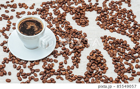 Cup of coffee and coffee beans on beige background with human 85549057