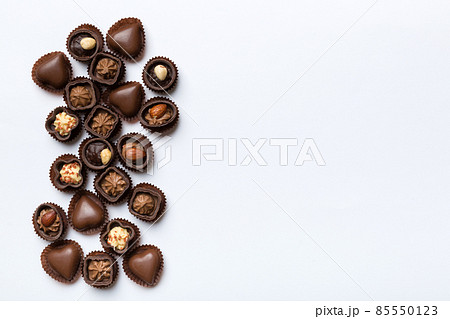 Different kinds of chocolates on colored table close-up. Top View and Flat Lay with copy space 85550123