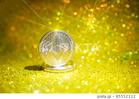 The reverse side is ether. Cryptocurrency ether is the coin of the future. Golden ether. Golden shiny background. High quality photo 85552112