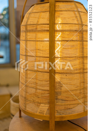 Handmade wicker lamps on wooden table.  85552123