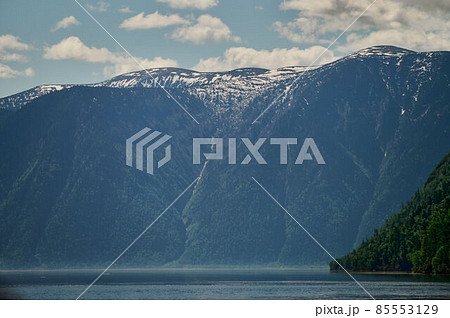 Landscape with boats in the water lake with views of the mountains. Teletskoye Lake Altai in Siberia. Landscape with boats in the water lake with views of the mountains. Teletskoye Lake Altai in Siberia. 85553129