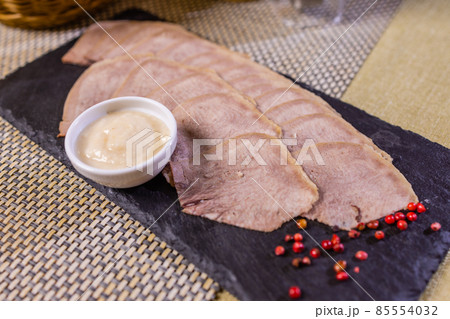 Sliced Beef Tongue Slices on Wooden Board. Sliced Beef Tongue Slices on Wooden Board. 85554032