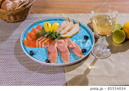 Smoked fish platter appetizer on the wooden table. 85554034