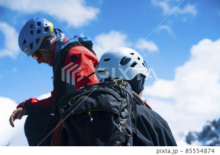 Two men climbs to the top of the mountain. Two men climbs to the top of the mountain. 85554874