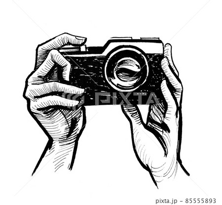 Hands holding camera. ink black and white drawing 85555893
