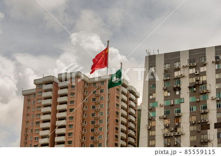 Flags of China and SAR Macau in front of residential buildings in Macau, China 85559115