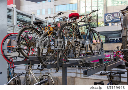 Bicycles stacked at a parking lot near Zhongguancun station of Beijing Subway Bicycles stacked at a parking lot near Zhongguancun station of Beijing Subway 85559948