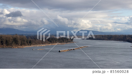 Aerial View of Tugboat in Fraser River and Mountain Landscape in background 85560028