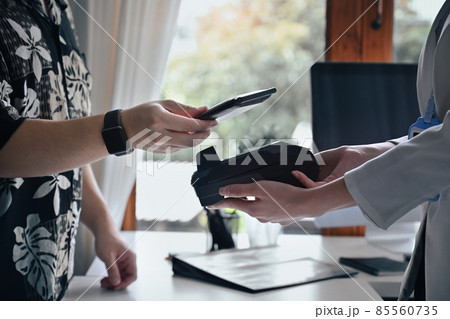 Customer using smart phone scanning for contactless payment at coffee shop. 85560735