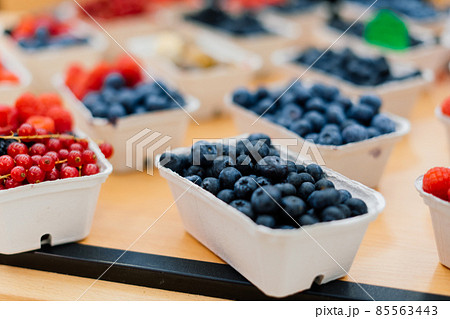 Blueberries and raspberries in box containers at a farmers market Blueberries and raspberries in box containers at a farmers market 85563443