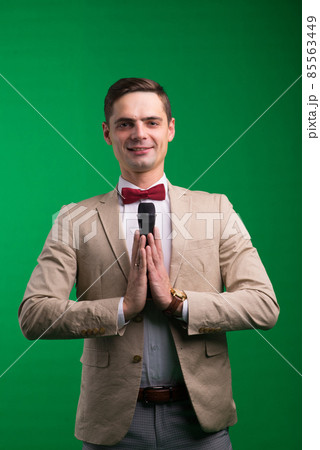 Portrait of a male announcer holding microphone, isolated on green, white background 85563449