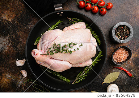 Whole raw free range chicken, on old dark rustic table background, top view flat lay 85564579