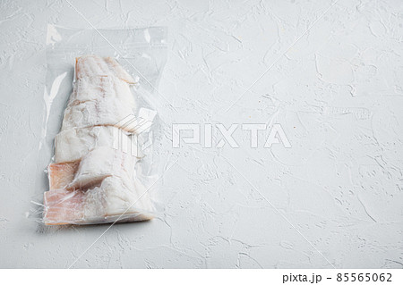 Raw haddock fish skinless, plastic vacuum packaged, on white background with copy space for text Raw haddock fish skinless, plastic vacuum packaged, on white background with copy space for text 85565062