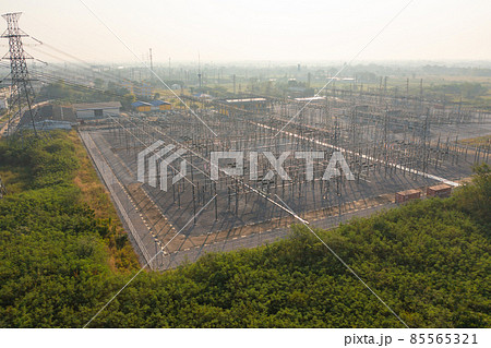 Aerial view of electricity generating, voltage poles. Power lines on utility tower and cable wires in energy electric technology, network, and industry. Generator pylon. Transmission and substation. Aerial view of electricity generating, voltage poles. Power lines on utility tower and cable wires in energy electric technology, network, and industry. Generator pylon. Transmission and substation. 85565321