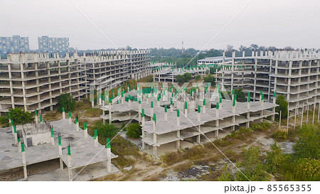 Aerial top view of abandoned apartment or hotel under construction site with structure. Top view of precast concrete slap floor. Development architecture buildings. 85565355