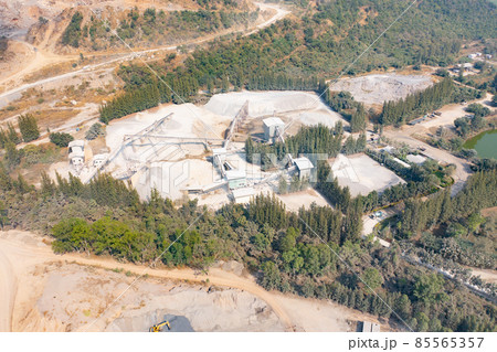 Aerial view of machine excavator trucks dig coal mining or ore with black grunge stone on ground in quarry with mountain hills. Nature landscape background in factory industry. Environment resources 85565357