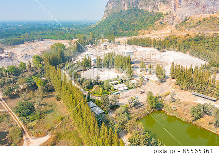 Aerial view of machine excavator trucks dig coal mining or ore with black grunge stone on ground in quarry with mountain hills. Nature landscape background in factory industry. Environment resources 85565361