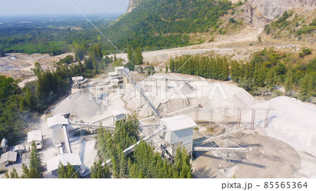 Aerial view of machine excavator trucks dig coal mining or ore with black grunge stone on ground in quarry with mountain hills. Nature landscape background in factory industry. Environment resources 85565364